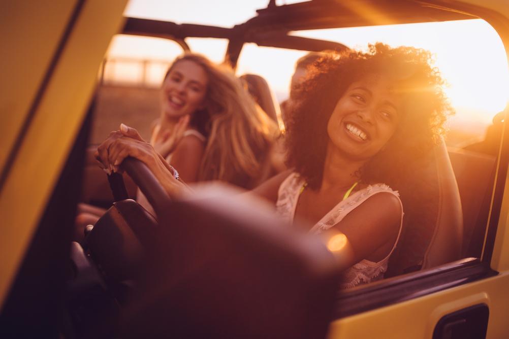 Woman driving her car with friends after winning the German Lotto